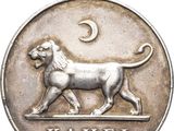 a close up of a silver medal with a lion on it