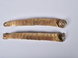 pair of antique brass plated brass door handles on a white background