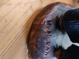 a close up of a metal object on a wooden table