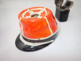 an orange hat sitting on top of a table next to a pair of scissors