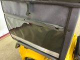 a bag on the back of a yellow golf cart