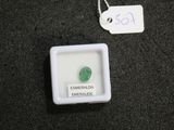 a small white box with a green stone in it