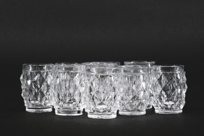 set of six crystal tumblers on a black background