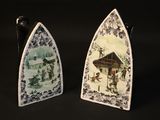 two decorative plates with pictures on them on a black background