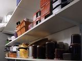 many containers on the shelves in the kitchen