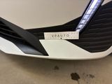 the front end of a white car with a sticker on it ' s bumper