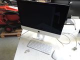 a computer sitting on a desk with a keyboard and mouse