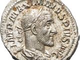 a silver coin with an image of a man on it
