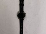 a watch that is laying on a white surface