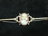 a close up of a gold ring with a pearl in it