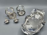 an image of a silver plate with a ring and other silver objects