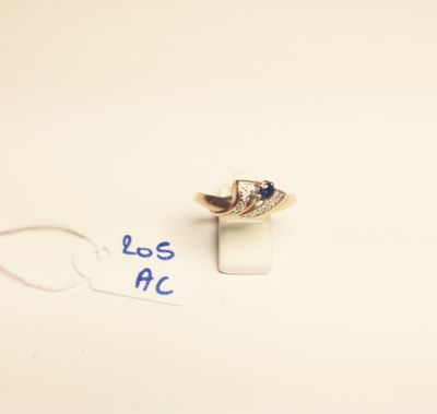 a close up of a ring on a white surface with a blue marker