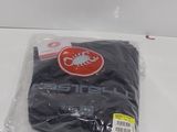 a black t - shirt in a plastic bag on a white surface