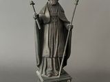 an image of a statue of a priest holding a staff