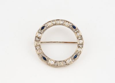 a close up of a broochle with blue and white stones