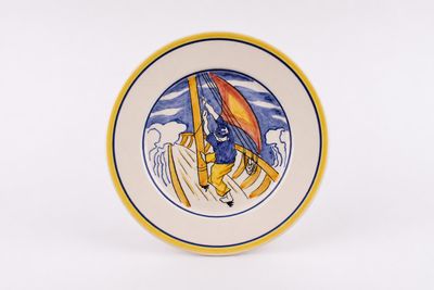 an image of a plate with a picture of a man on a boat