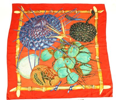 an image of a red scarf with a bunch of different items on it