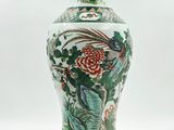 a vase that has a bird and flowers on it