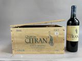 a bottle of wine sitting next to a wooden box