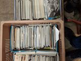 beaucoup de disques dans une boîte posée par terre