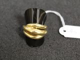 a black and gold ring with a white tag on it