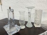 three glass vases sitting on a table next to each other