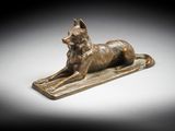 an egyptian bronze statue of a dog on a tray
