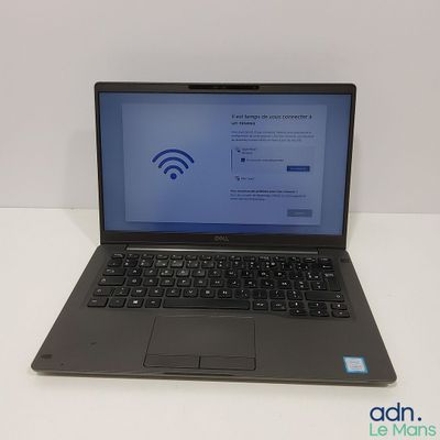 a laptop computer sitting on a table with a wifi sign on the screen