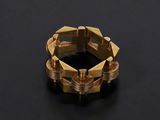 a close up of a gold ring on a black surface