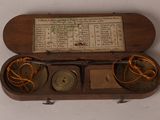 a wooden box with a clock inside of it on a table