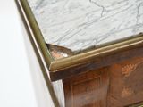 a marble top on the top of a wooden cabinet