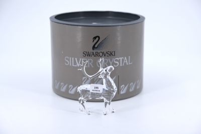 a tin of silver crystal with a horse figurine on it