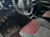 the interior of a small car with a steering wheel and dashboard