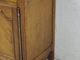 an old wooden cabinet with a door and a drawer on top of it