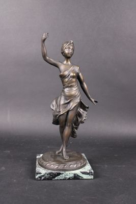 bronze statue of a woman holding a tennis racquet on a marble base