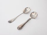 two spoons and a spoon on a white surface