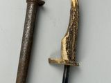 an image of a knife and a hammer on a white surface