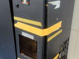a black and yellow refrigerator sitting in the corner of a room
