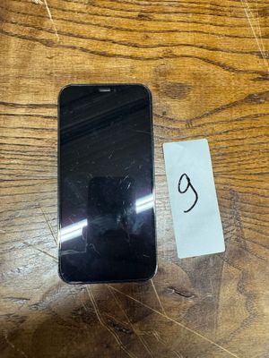 an image of a cell phone sitting on top of a wooden table