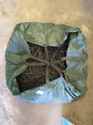 a bag with a bunch of grass in it on the floor