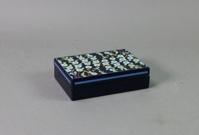 a small black box with a flower pattern on it