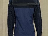 an image of a mannequin mannequin wearing a blue jacket and white pants