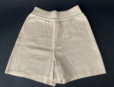 a close up of a pair of white shorts on a black surface