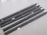 four pieces of black metal on a white table