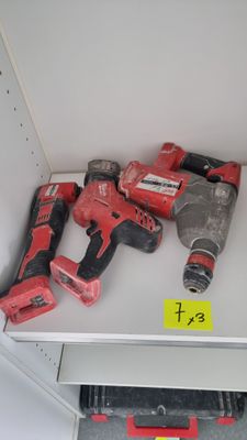 two cordless drillets on a shelf in a room