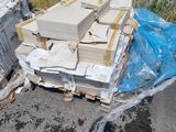 a pile of boxes sitting on the ground next to a fence