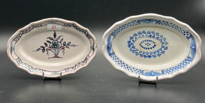 two plates with designs on them sitting on a table