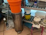 a large orange container sitting on a metal shelf in a kitchen