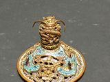 a gold and blue plate with a dragon on it
