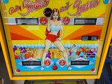 a pinball machine that has a pinball girl on it